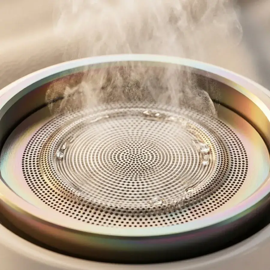 Close-up macro of ultrasonic vibrating titanium micro-mesh aperture plate